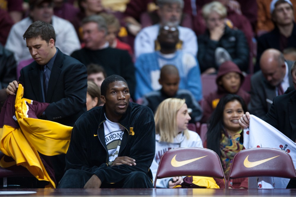Gophers forward Trevor Mbakwe sits on the bench during a game against Purdue on Sunday night at Williams Arena. Mbakwe ended his season early due to an ACL injury.