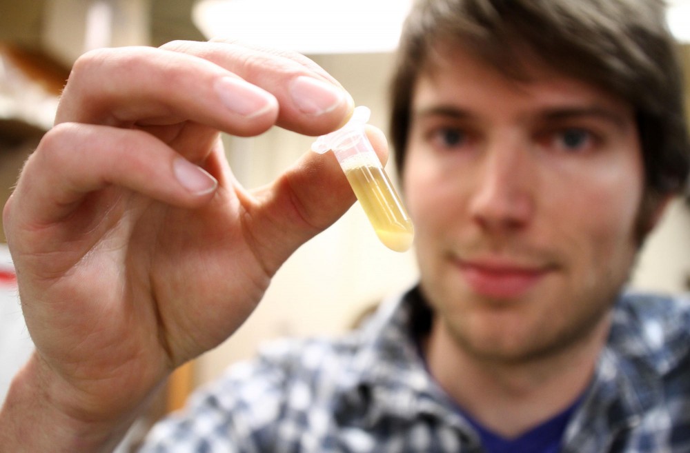 William Ratcliff, a postdoctoral associate in the department of ecology, evolution and behavior at the University of Minnesota, holds up a tube of yeast that has just clustered Monday, January 23 at Snyder Hall in Saint Paul.