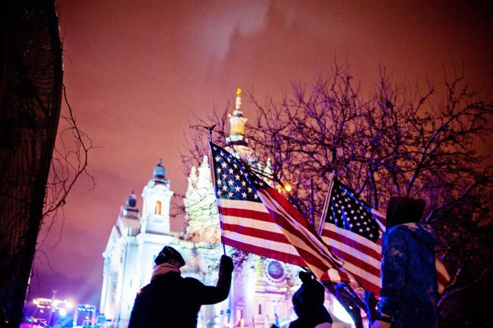 Fans wave American flags during the Red Bull Crashed Ice event Saturday in St. Paul.