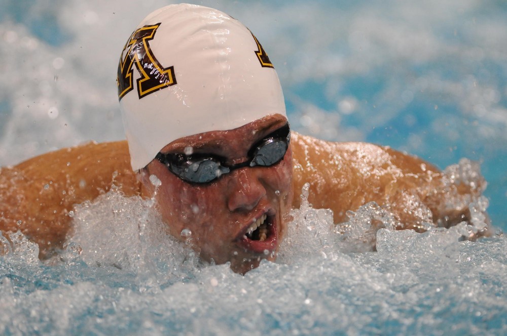 Minnesota Freshman CJ Smith takes a breath during the 200-meter individual medley at the Aquatic Center on Friday night.  The Gophers took the top 6 places in the 200 IM.