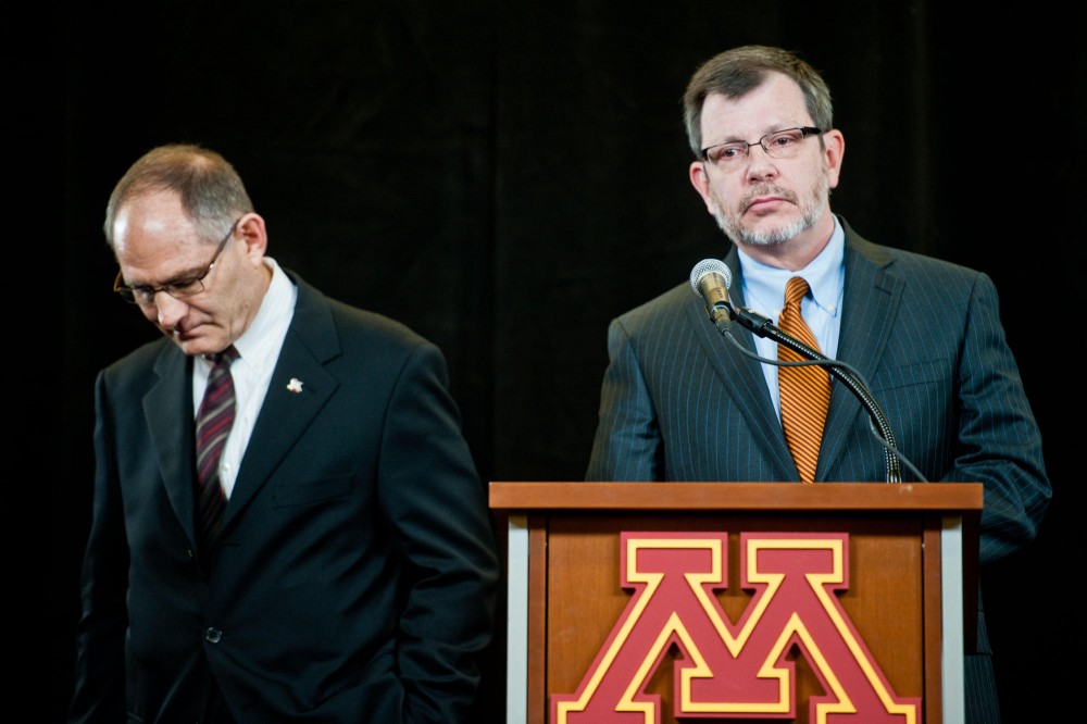 Minnesota athletic director Joel Maturi, left, announced he would step-down from his position during a press conference with University President Eric Kaler, right, on Thursday morning at TCF Bank Stadium.