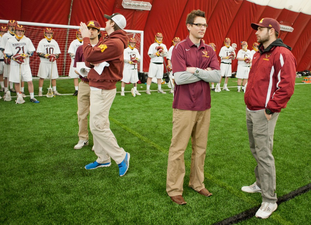 Gophers assistant coach Aime Caines and head coach Joe Cinosky speak on the sidelines just before the start of the Gophers game against Duluth on Saturday at the Sports Dome.  Caines also coaches for the Minnesota Swarm.