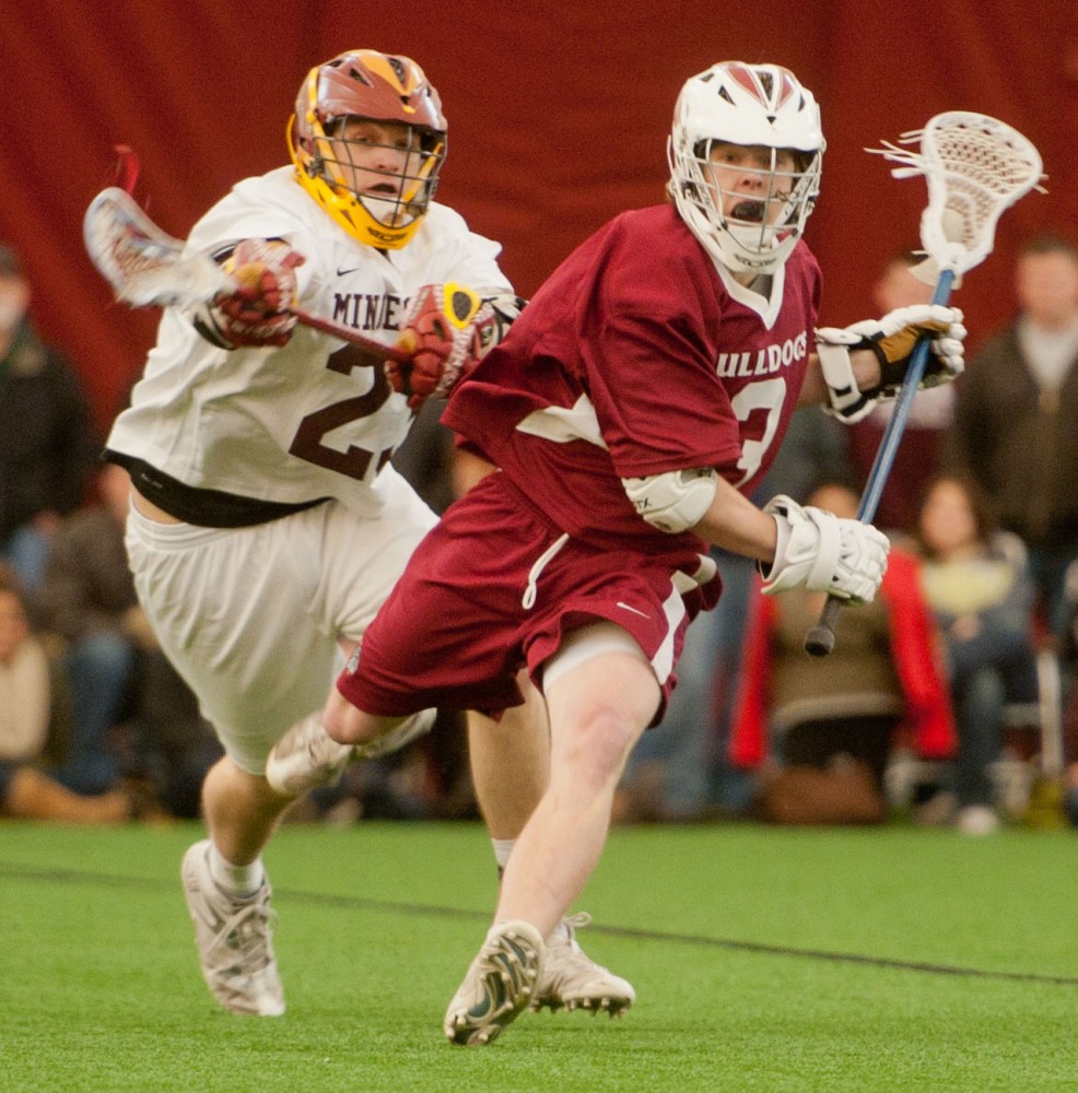 Bulldogs midfielder Ben Blaeser evades Gophers midfielder Tim Puch during their game Saturday at the Sports Dome.  The Bulldogs defeated the Gophers 11-9.