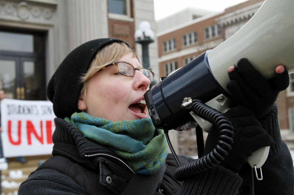 Alumna Stephanie Taylor rallies a crowd gathered on Thursday at Morrill Hall to protest tuition hikes and high administrative salaries.