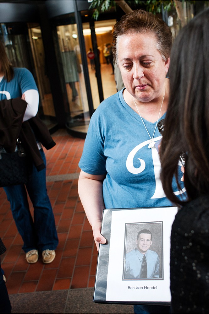 Anne Van Handel holds up a picture of her son Ben Van Handel at the Hennepin County Government Center on Monday morning following the sentencing of Timothy Bakdash. 