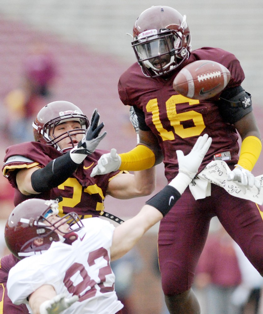 Minnesota defensive backs Grayson Levine and Steven Montgomery and wide receiver A.J. Barker collide for the ball Saturday during the annual Gophers spring game at TCF Bank Stadium.