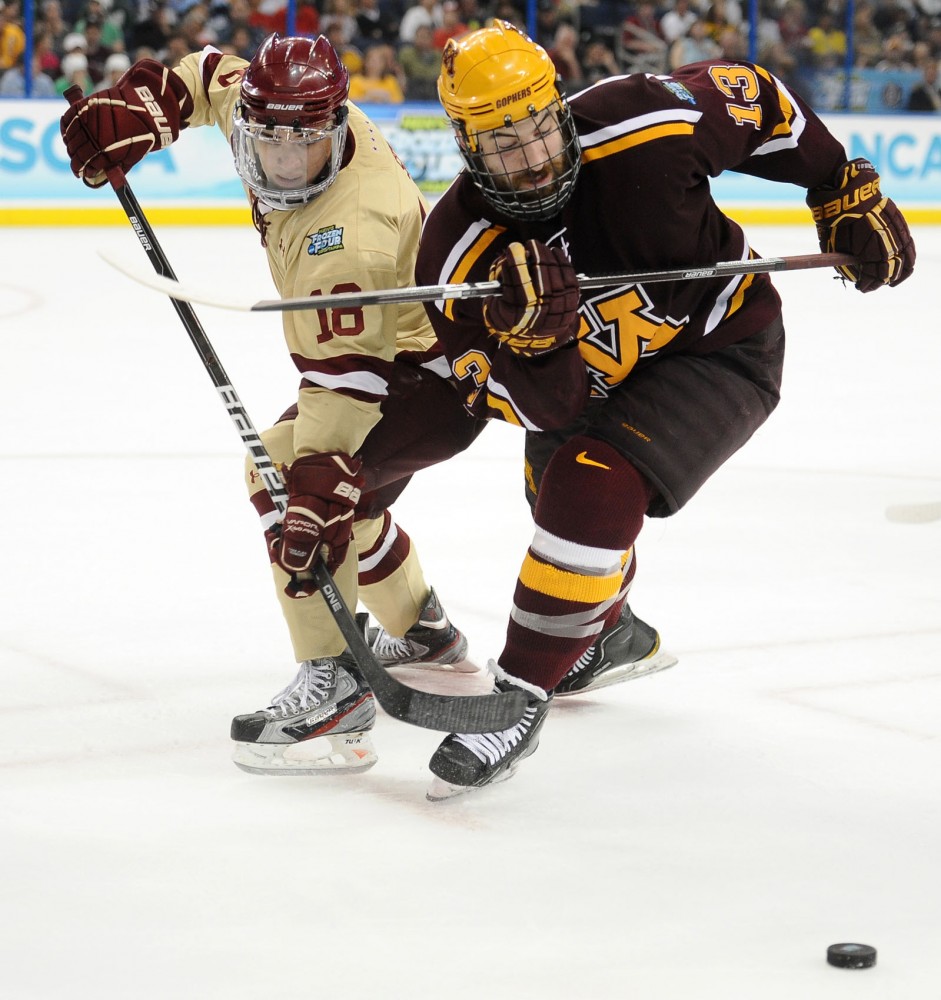 Gophers forward Nico Sacchetti fights Eagle’s forward Michael Sit for the puck Thursday in Tampa, Fla.