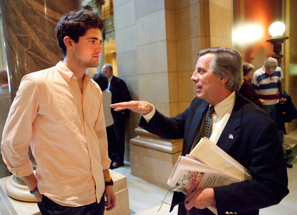 Minnesota Student Association member Colin Burke speaks with Tom Devine, a candidate for the Board of Regents, about the importance of the University of Minnesota to the state on Friday at the Capitol. Students pushed legislators during “Support the U Day” to give more financial support to the University.