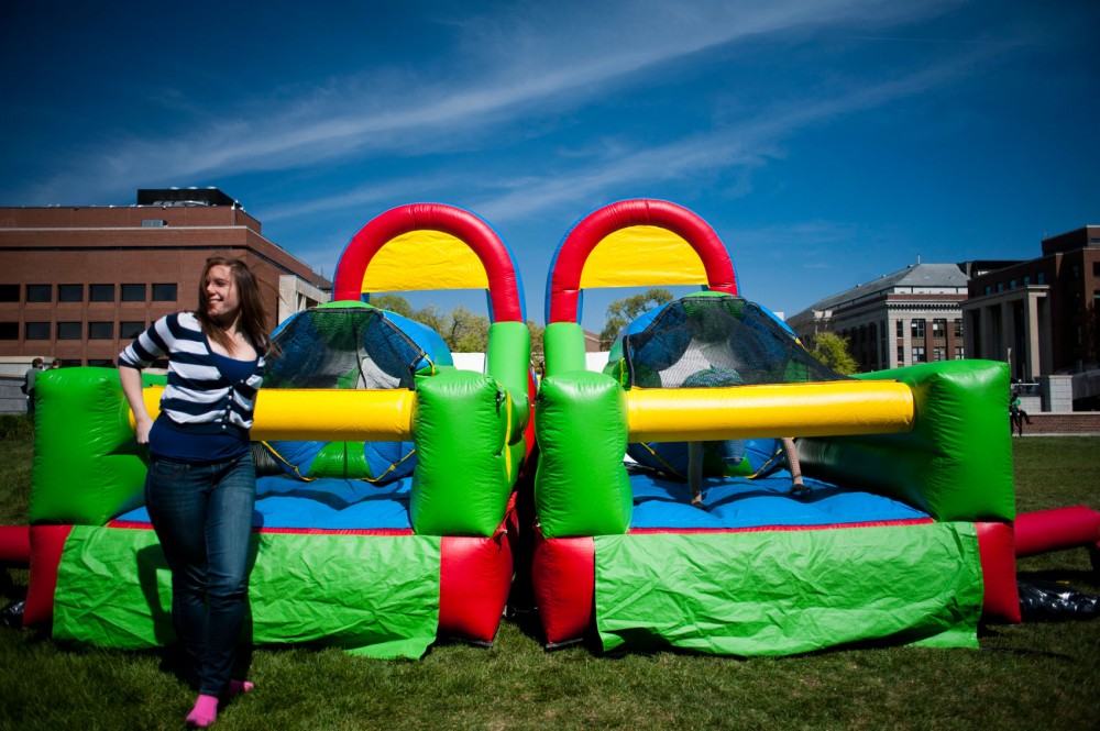 Kinesiology freshman Kim Tafaro regains her composure after a run through a inflatable obstacle course, part of 60K Day, on the Coffman Union Front Plaza.