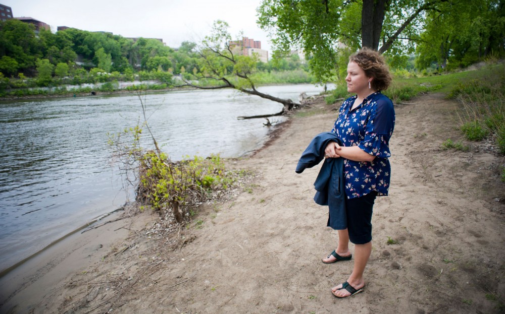 Outpatient clinic assistant and front desk team leader Vetris Pate walks along the river to de-stress during her lunch break Tuesday on the East River Flats. Pate said what affects her most is the reactions from students whom she often tells won’t be able to see a provider for almost two weeks — and worrying about that they might do before then.