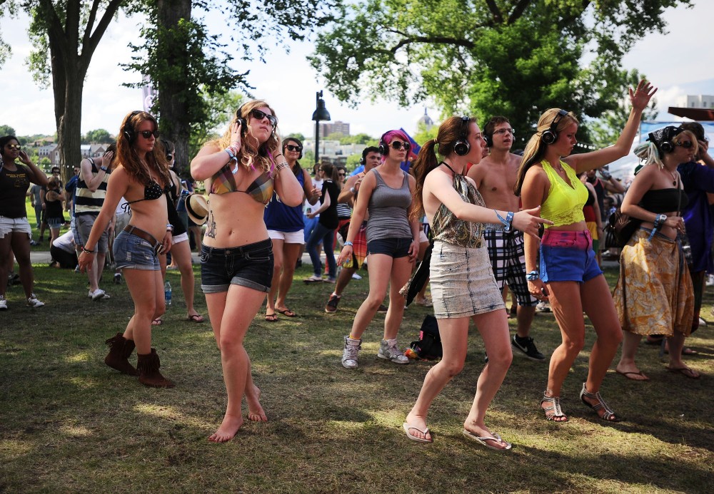Rivers Edge attendees jam at the Silent Disco stage Sunday at Rivers Edge Music Festival in St. Paul, Minn. Festival goers donned headphones to listen to a pair of dueling DJs performing silently on stage.