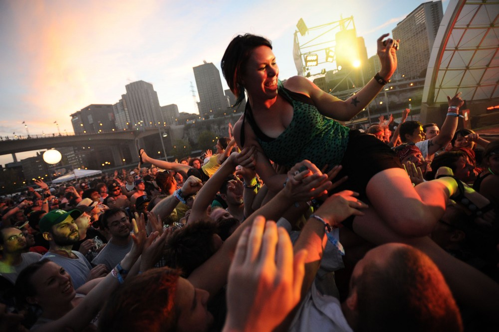 Holly Marie of Des Moines, Iowa crowd surfs during Diplos set Sunday at Rivers Edge Music Festival in St. Paul, Minn.
