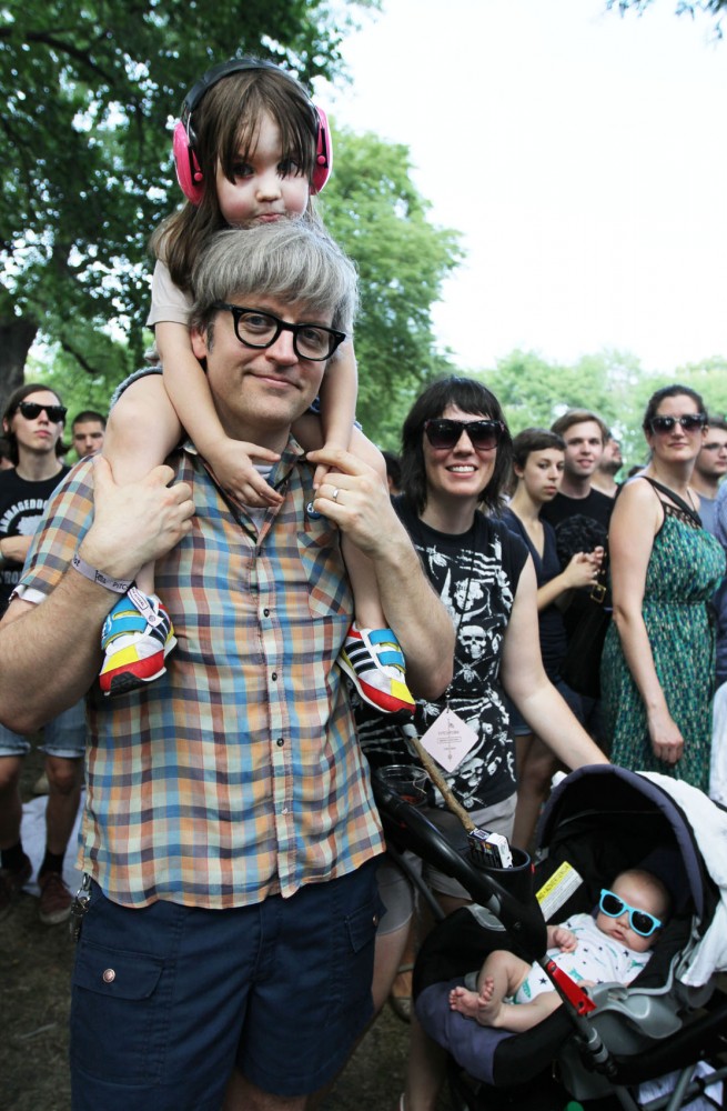 Parents Bill and Lisa Roe watch Thee Oh Sees with their 3-year-old daughter Ronnie and their 2-month-old son Arthur on Sunday at Pitchfork Music Festival in Chicago. The Roes own a Chicago-based record label named Trouble in Mind.