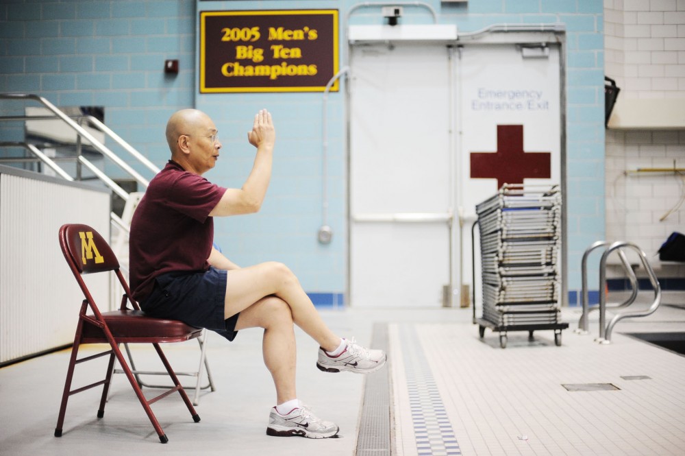 Chen critiques Bryant’s dive during practice July 3 at the University Aquatic Center. Chen, a former diver, was a coach for the Chinese national team from 1983 to 1991 before immigrating to the United States in 1992.