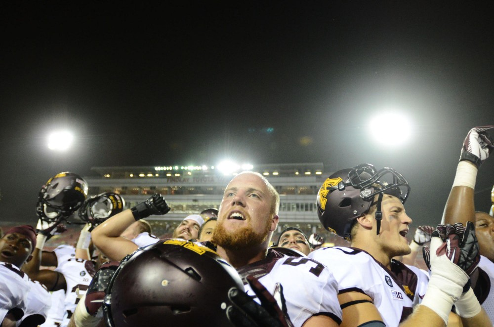 Minnesota offensive lineman Zac Epping and his team stand before Minnesota fans after defeating UNLV in triple overtime.