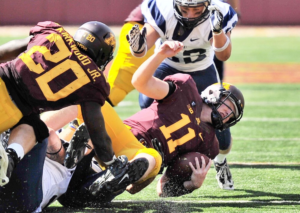Minnesota quarterback Max Shortell receives a hard hit during Saturday’s game against New Hampshire at TCF Bank Stadium. Shortell played much of the fourth quarter as the Gophers routed the Wildcats.