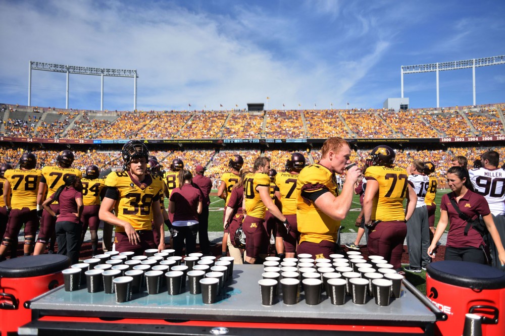 Minnesota football players refresh themselves with Powerade on the sidelines during Saturday’s game against Western Michigan at TCF Bank Stadium. Players can choose between Powerade and ice water.