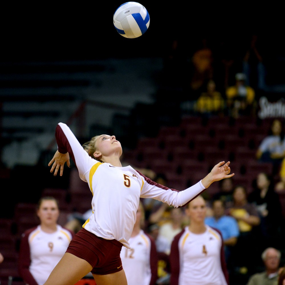 Minnesota libero Kalysta White spikes the ball during the second match of the night. 