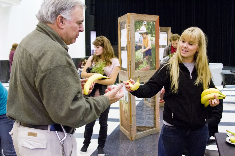 Peter Christodoulou, left, and nutrition junior Chelsey Bowman, right, talk about the benefits of bananas during Tuesday’s Food Day at Coffman Union. The event featured local businesses and organizations that promote healthy, and often homegrown, foods.