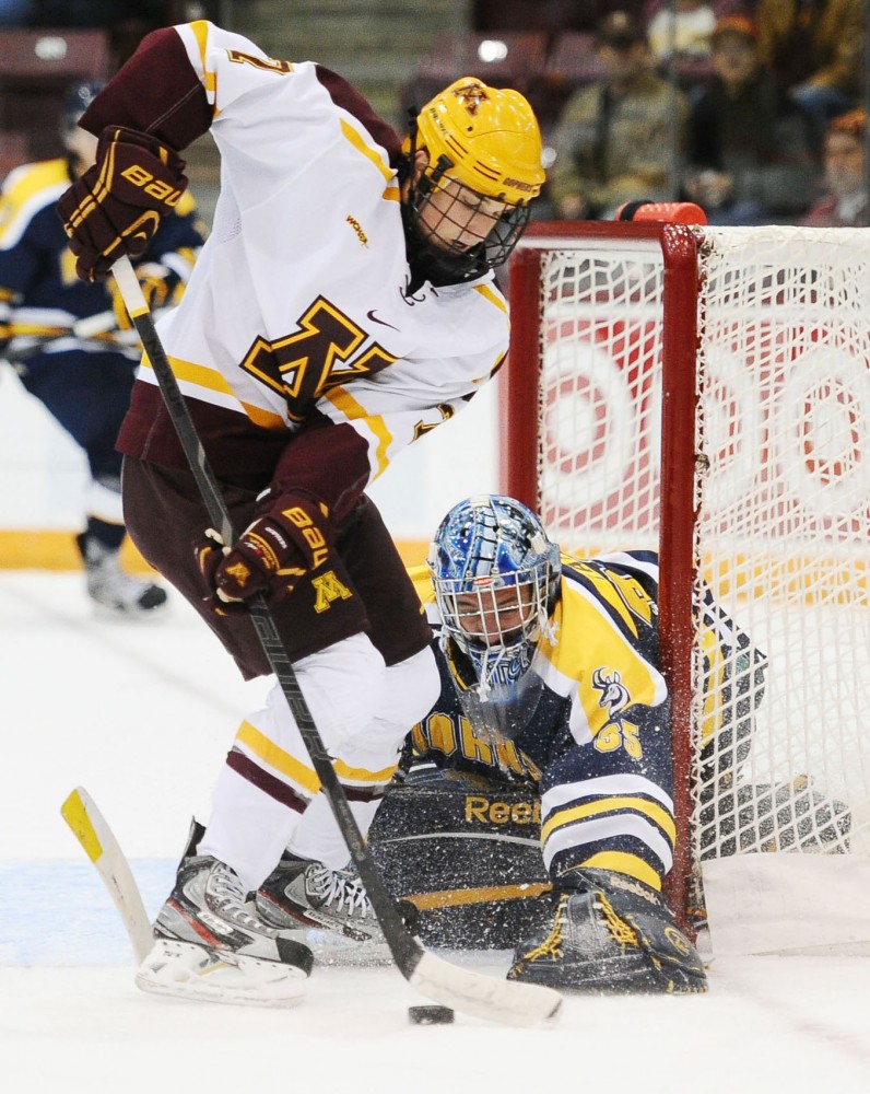 Minnesota forward Nick Bjugstad fights the puck away from Lethbridge goalie Dylan Tait on Saturday at Mariucci Arena.