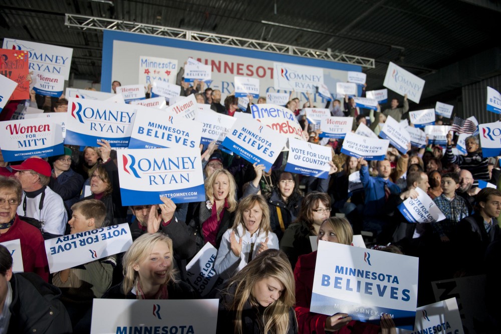 Mitt Romney and Paul Ryan supporters cheer while waiting for Ryans appearance Sunday, Nov. 4, 2012,  at the Sun Country Airlines hanger at the Minneapolis/St. Paul International Airport. 
