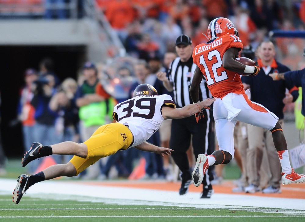 Minnesota kicker Jordan Wettstein (39) pushes Illinois wide receiver Ryan Lankford out of bounds on Nov. 10, 2012 at Memorial Stadium in Champaign, Ill.