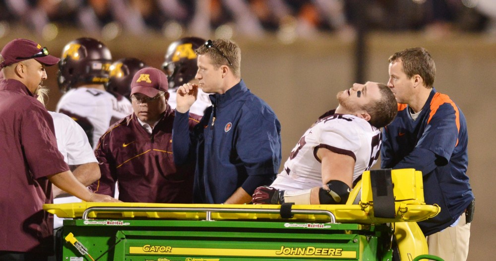 Minnesota offensive lineman Zach Mottla (62) leaves the field after suffering a severe leg injury on Nov. 10, 2012 at Memorial Stadium in Champaign, Ill.
