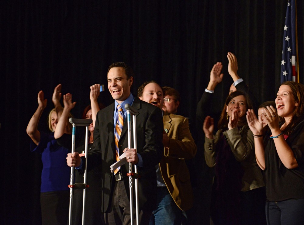 Dan McGrath, the executive director of TakeAction Minnesota, cheers with his colleague in celebration of the result of the amendment at the MN United for All Families election event at the St. Paul Rivercentre. 