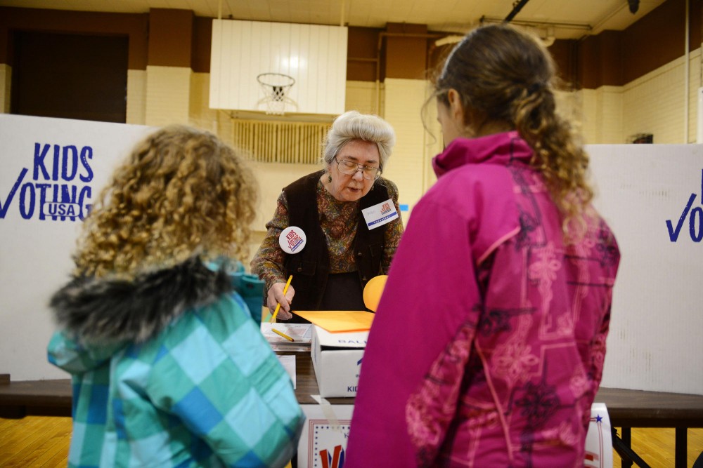Kids Voting volunteer Sharon Bigot, works the Kids Voting stand at Pratt Community School, in Minneapolis. This is her 4th time volunteering for Kids Voting.
