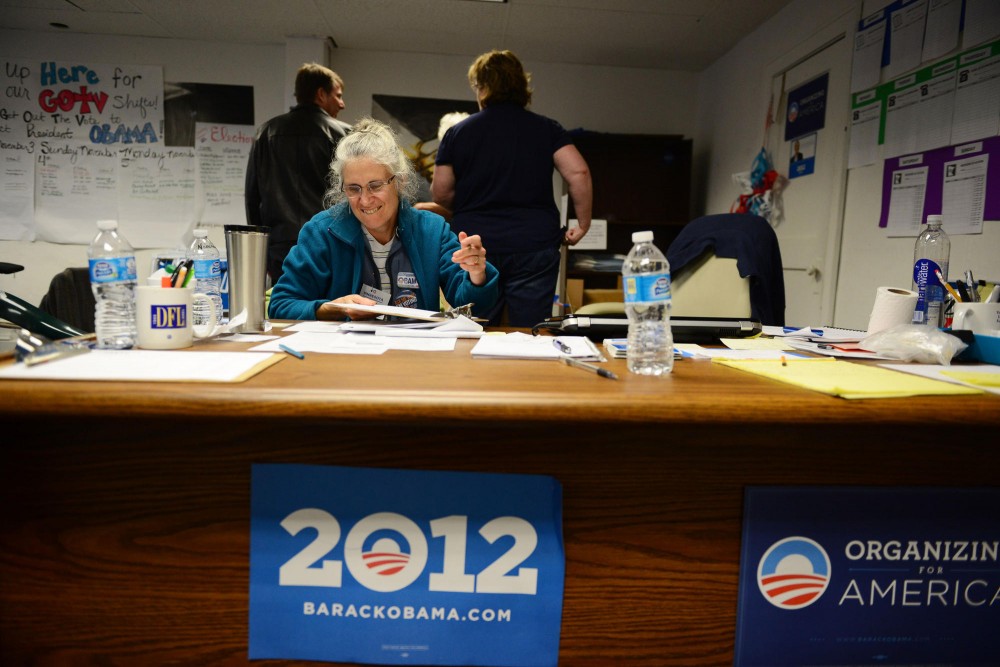 Volunteer Nanciann Kuse helps organize phone banking volunteers for the Obama campaign office in Minneapolis, Tuesday afternoon. 
