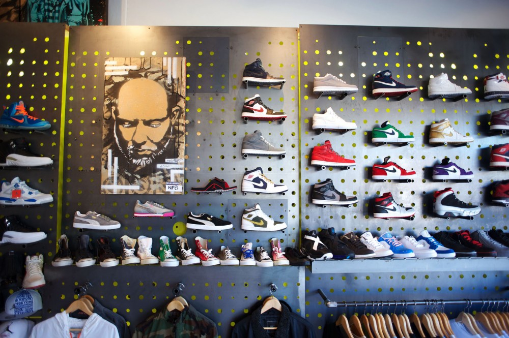 Sneakers and work by local artists adorn the walls of STUDIiYO23 in Uptown. The high end sneaker shop is one-third art gallery and also occasionally serves as a performance space.