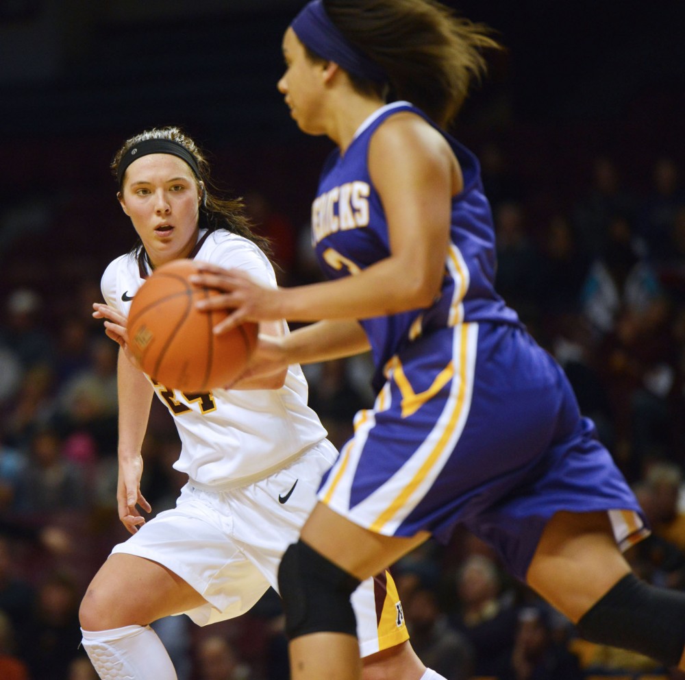 Minnesotas Mikayla Bailey keeps pace with Minnesota States Aubrey Davis during Sundays game in Williams Arena. 