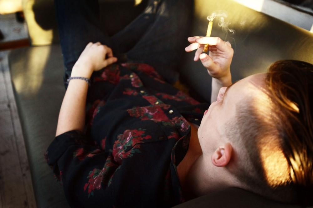 A University student smokes marijuana at his Minneapolis home Monday afternoon. A 2010 study found that about 13 percent of University students had used marijuana in the previous month.