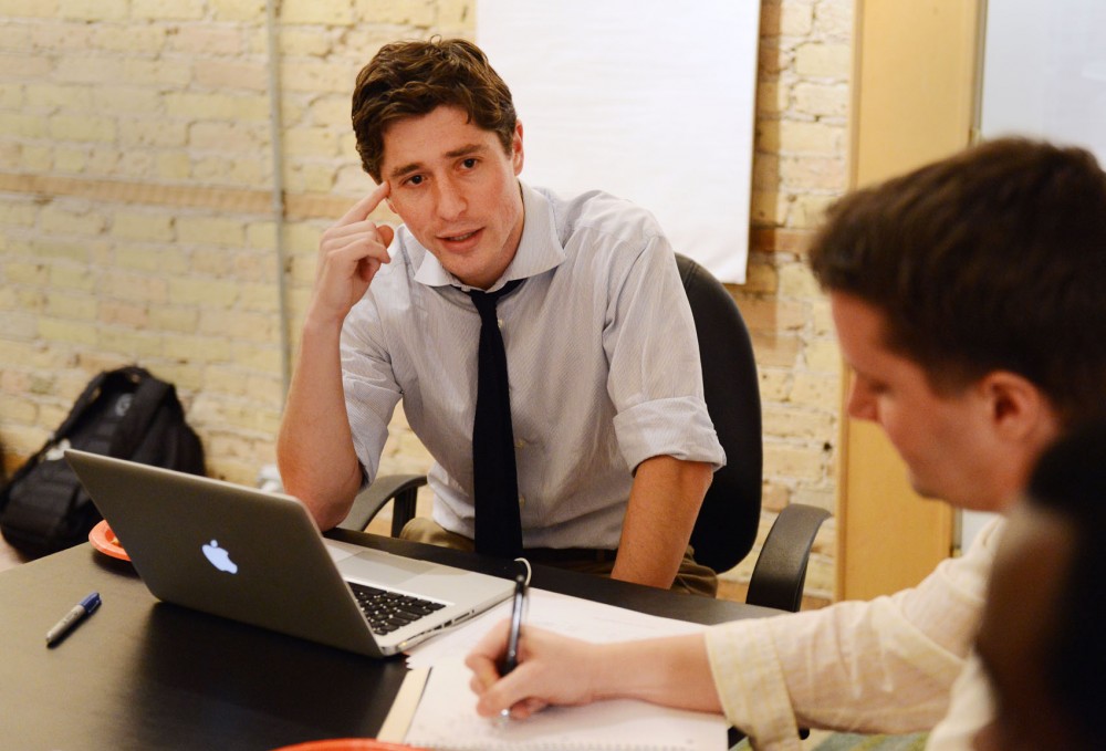 Minneapolis attorney Jacob Frey, center, talks campaign strategy on Thursday at his home in the Nicollet Island neighborhood. Frey will be running against incumbent Diane Hofstede to represent Ward 3 on the Minneapolis City Council.