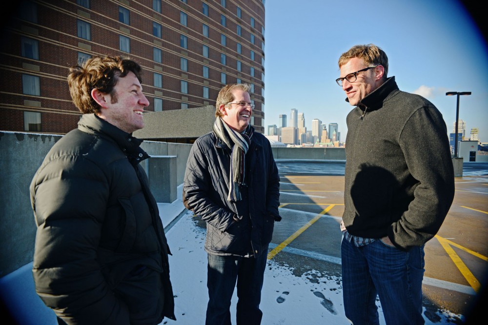 Solhem Companies developer Curt Gunsbury, center, talks with friends and investors Pete Lemieux, left, and Ben Cramer on a parking ramp overlooking the new 7west Apartments construction site Saturday on West Bank.