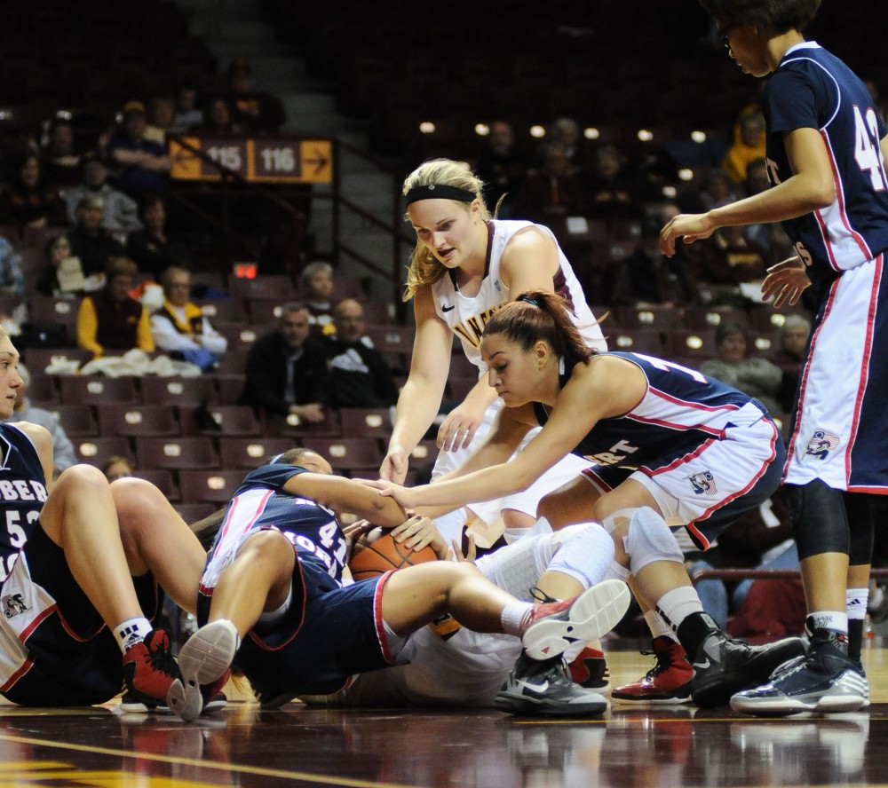 Minnesota players fight for the ball against Robert Morris on Sunday at Williams Arena.