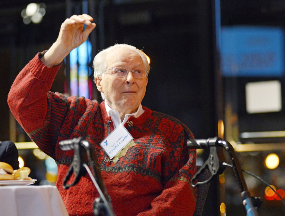 Mead Cavert remains the last person in the room his hand in the air as the speaker works back though the decades from the 1990s to 1940s, asking how long the audience has been involved at YMCA at organizations 125th anniversary celebration Tuesday evening at McNamara Alumni Center.