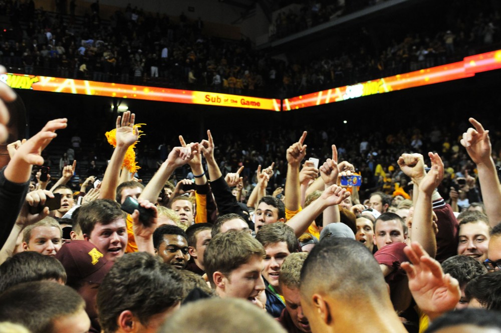 Fans storm the Williams Arena court.