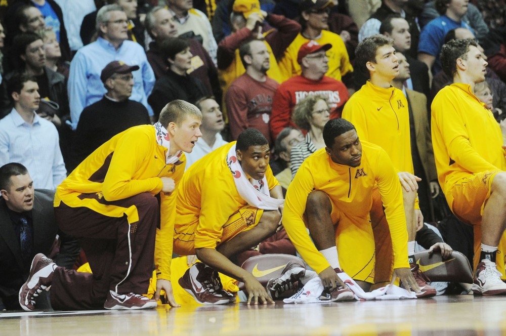 Gopher teammates anxiously watch a play.
