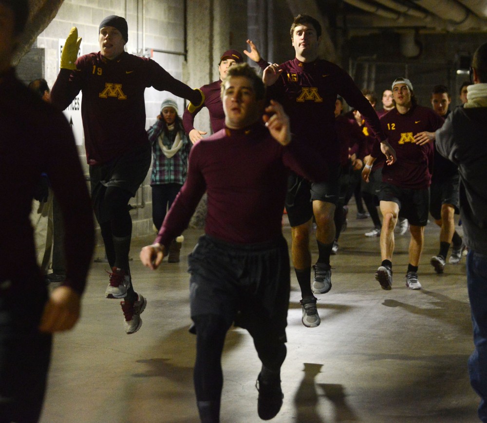 The Gophers warm up before the game against Wisconsin at Soldier Field in Chicago on Sunday.