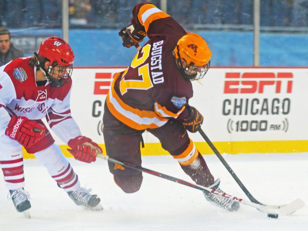 Minnesota forward Nick Bjugstad (27) races ahead of Wisconsin forward Tyler Barnes on Sunday at Soldier Field in Chicago. The Badgers beat the Gophers 3-2.