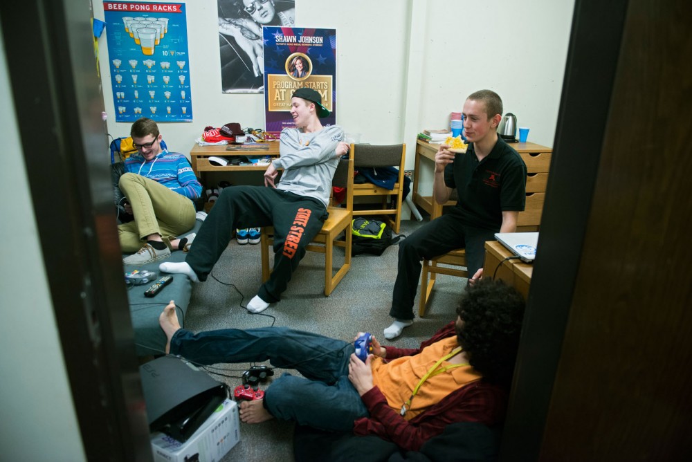 Freshmen Ian Niewald, left, Jason Murray, Kevin Wollner and Karl Amjad-Ali relax and play video games Tuesday, Feb. 19, 2013, in Bailey Hall. Students in this dorm are placed in gender-separated wings, making it more difficult to find friends of the opposite gender.