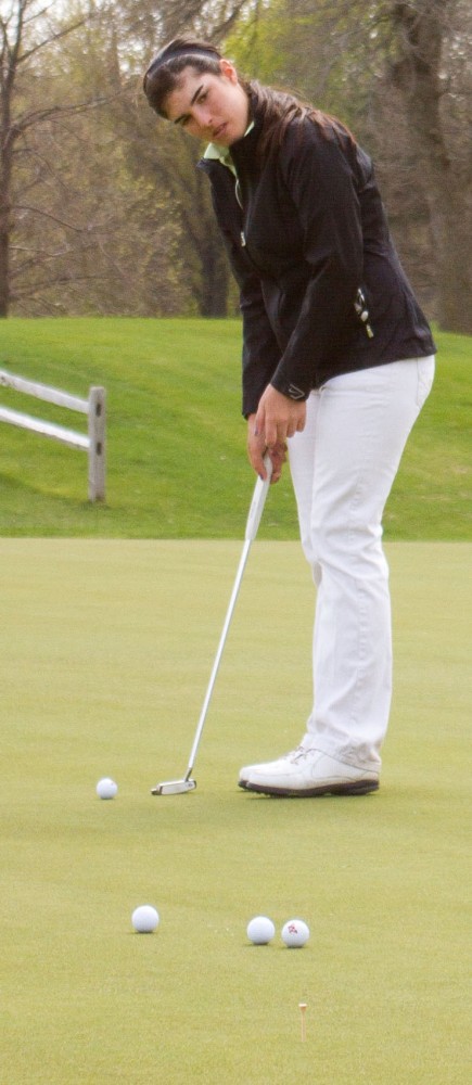 Carmen Laguna practices putting Tuesday, April 17, 2012, at Les Bolstad Golf Course in Falcon Heights, Minn.