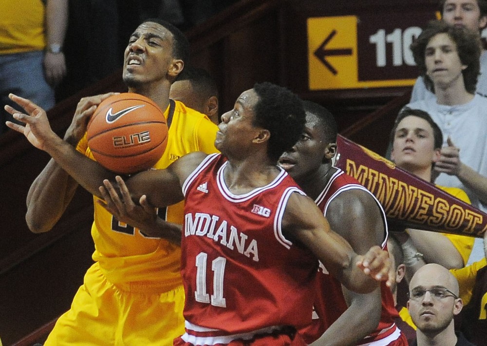 Minnesota guard Austin Hollins (20) fights for the ball against Indiana guard Kevin Ferrell on Tuesday, Feb. 26, 2013, at Williams Arena. The Gophers defeated No. 1 Indiana 77-73.