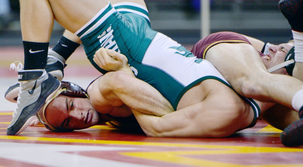 Minnesotas Cody Yohn tries to pin down Michigan States Nick Proctor on Sunday, Feb. 3, 2013, at the Sports Pavilion. Yohn successfully pinned down Proctor and ended the match quickly.