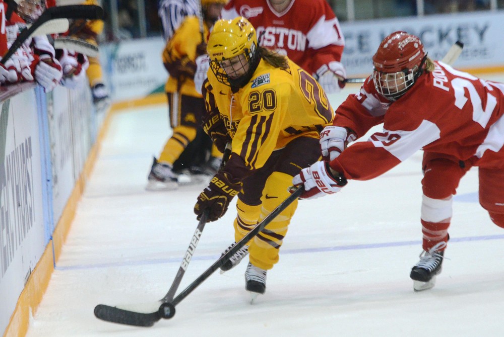 Boston Universty forward Marie-Philip Poulin attempts to steal the puck from Minnesota forward Meghan Lorence, Sunday at the NCAA title game at Ridder Arena.