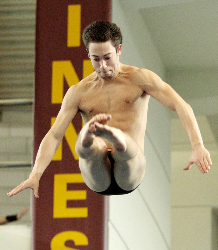 Mikey Ross dives Saturday, Jan. 28, 2012, at the University Aquatic Center.