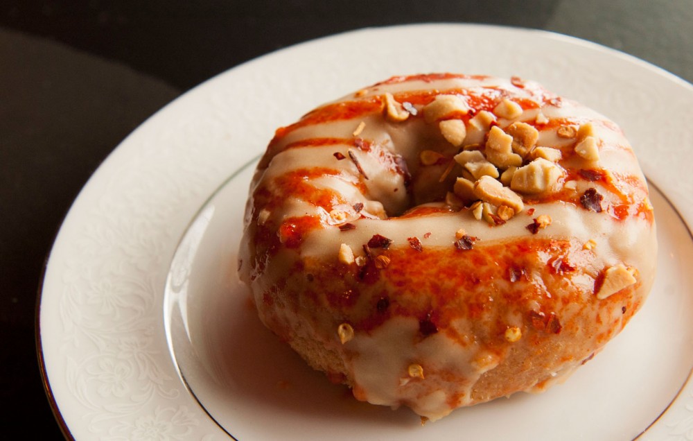 The Chart Topper doughnut covered with peanut butter and spicy Sriracha sauce at Glam Doll Donuts on Eat Street in Minneapolis. 