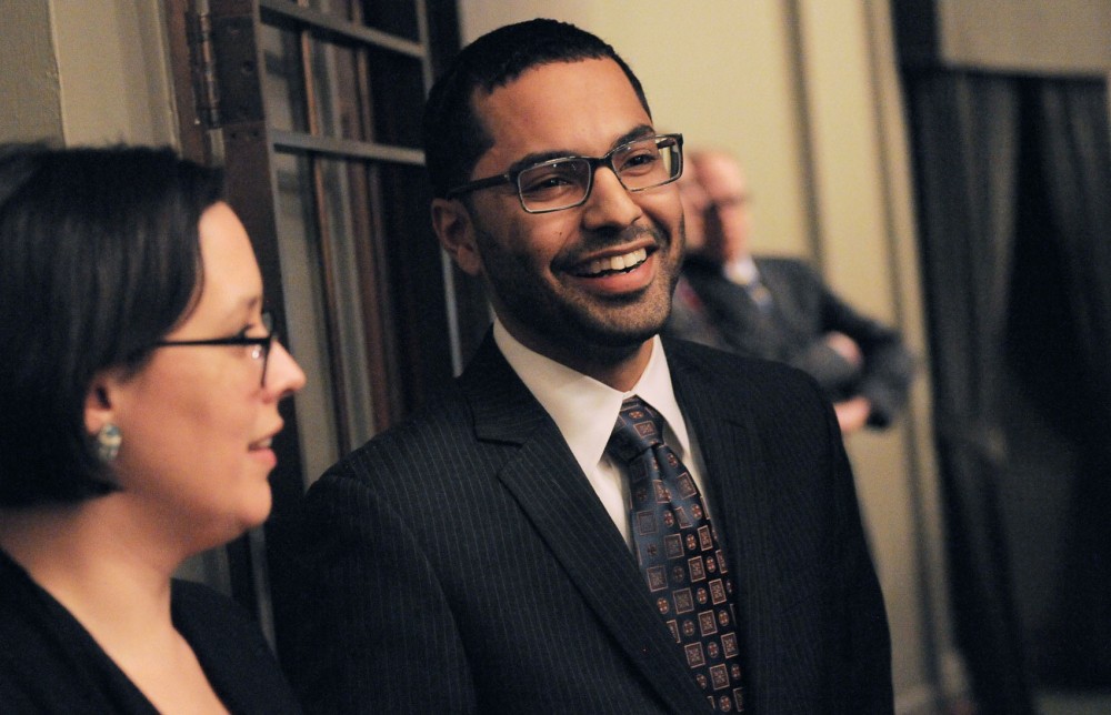 Abdul Omari speaks with current student representative at-large Maureen Ramirez after being selected to be the new student regent position on the board on Wednesday, March 6, 2013, at the State Capitol.