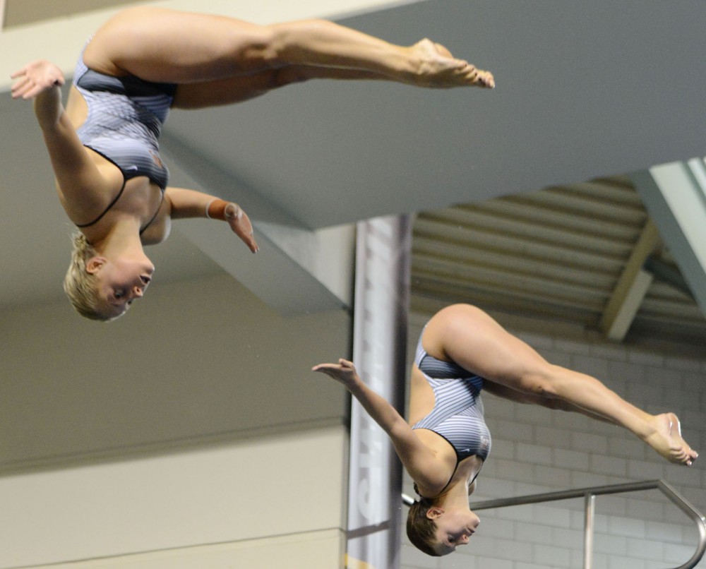 Minnesotas Maggie Keefer and Katie Grunawalt dive Wednesday, Feb. 20, 2013, at the University Aquatic Center.